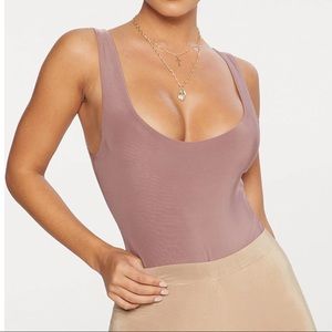 Pretty little thing, Size 4. body suit. Mauve.